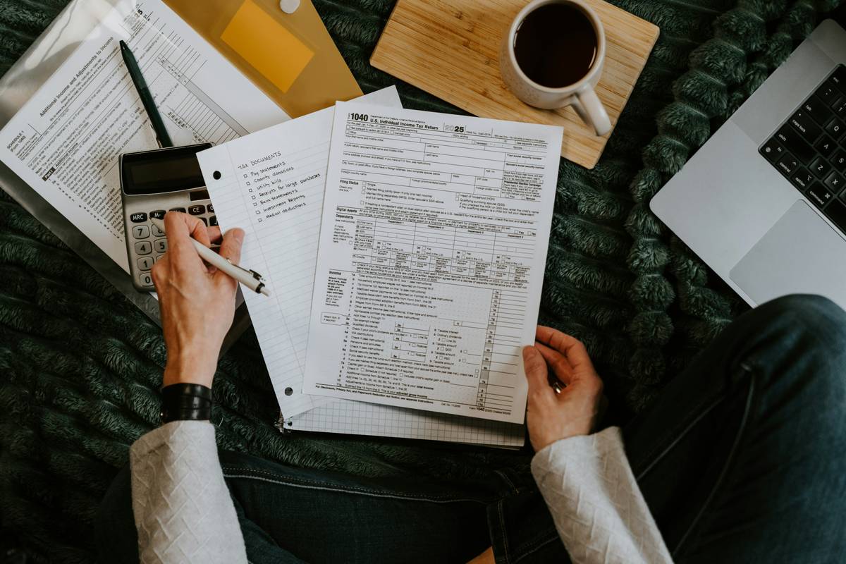 Person reviewing monthly expenses with sticky notes labeled 'values' on a notebook; value based spending consciou habit explain
